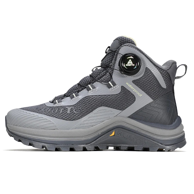 Gris et orange Humtto HT-260587E mid-top bottines alpinisme avec protection Splash-proof, semelle crantée et molette latérale de serrage, présentées sur fond blanc avec logo Humtto. Idéales comme chaussures hydrophobes pour enfants aventuriers.