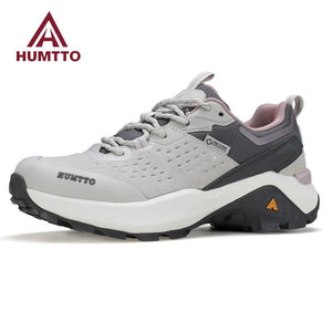 Chaussures de randonnée / trail low-top pour femme "HUMTTO - HT-160560B" grises et blanches en cuir véritable, semelle noire, accents roses, logo Humtto sur le côté et le dessus-idéales pour la randonnée.