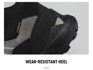 A single Humtto - HT-250366A mid-top randonnée/bottine d'expédition pour homme, gris et noir, antidérapant, protection splash-proof, maintien cheville, lacets, logo Humtto latéral et languette, sur fond blanc.