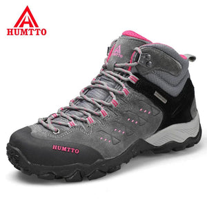 Les HUMTTO - HT-290027B mid-top randonnée bottines pour femme, en gris et noir avec accents roses, sont présentées en angle sur fond blanc. Elles offrent une protection splash-proof et une semelle antidérapante pour plus d'adhérence.