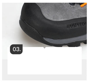Chaussure de randonnée gris et noir Humtto "HT-250486A" pour homme, avec des accents orange, du cuir véritable, des œillets métalliques, une semelle robuste et la technologie Static Waterproof, montrée de profil sur fond blanc.