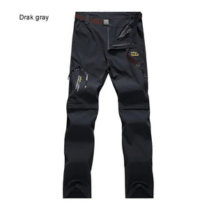 Pantalon de randonnée TRVLWEGO 2 en 1 gris foncé, poches zippées, logo Outdoor, séchage rapide, short amovible.