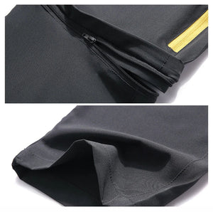 Gros plan sur pantalon de randonnée Trvlwego AD083 noir 2-en-1, poche zippée, bande jaune, déperlant et séchage rapide.
