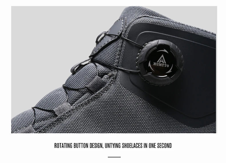Les chaussures de randonnée Humtto HT-220838A pour hommes sont dotées d'une protection contre les éclaboussures, d'un système de laçage à cadran, d'un design gris et noir avec une bande de roulement orange, de logos visibles, et sont des chaussures de randonnée parfaites pour les sentiers accidentés.