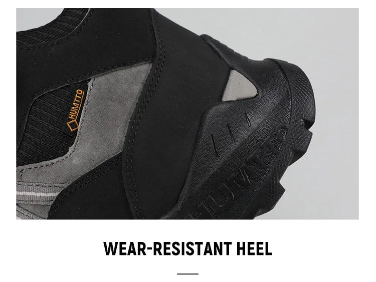 A single Humtto - HT-250366A mid-top randonnée/bottine d'expédition pour homme, gris et noir, antidérapant, protection splash-proof, maintien cheville, lacets, logo Humtto latéral et languette, sur fond blanc.