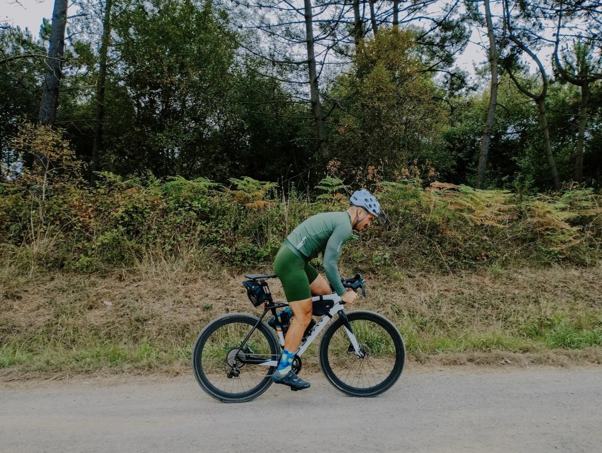 Le maillot de cyclisme unisexe à manches longues blanc DAREVIE "DVJ187" est doté d'une protection UV-SPF30+/SPF50+, d'une fermeture éclair sur le devant, de logos discrets, d'un tissu respirant et de manches en maille 3D pour plus de confort. Montré sur un fond uni.